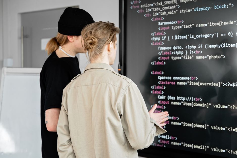 Developers collaborating around monitors showing WordPress monorepo code and architecture